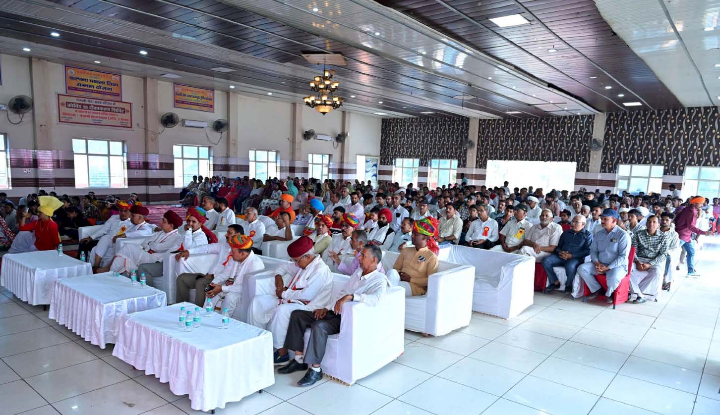 Community members and guests seated inside a hall during the student ceremony