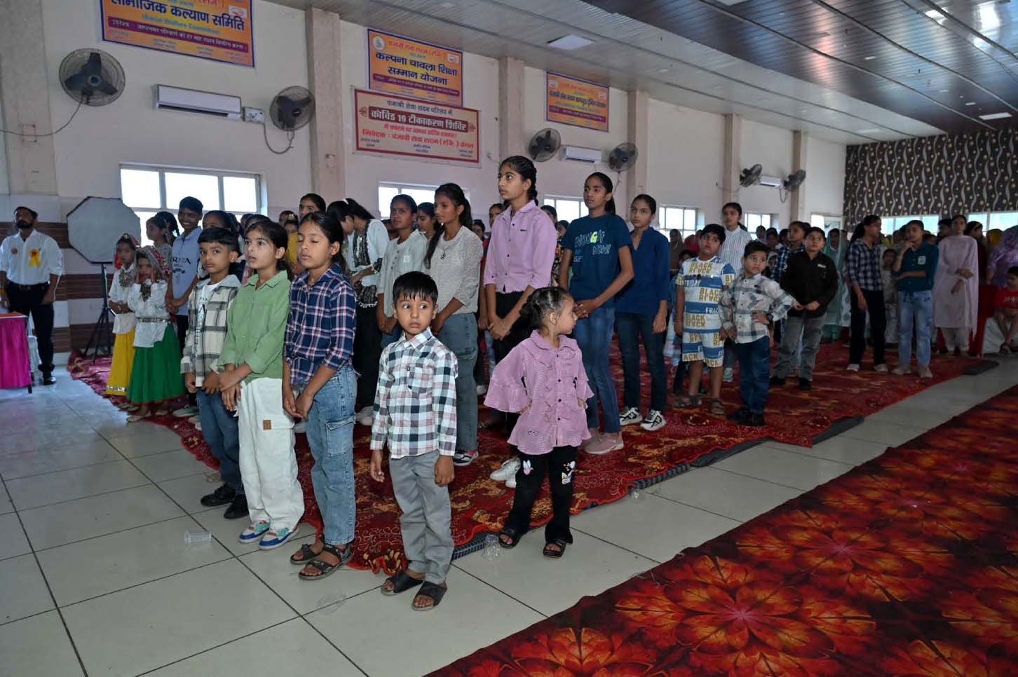 Children and young participants standing together inside the event hall